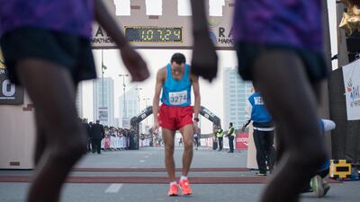 Mohammed Ait Mamas Touda of Morocco crosses the finish line in the elite race.