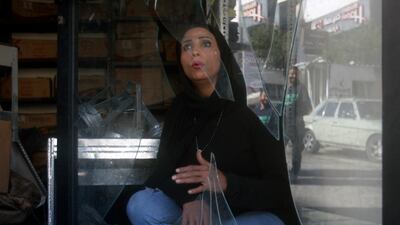 A woman at a shop damaged in Friday's explosion in Burj Shamali Palestinian refugee camp in Tyre, Lebanon. AP