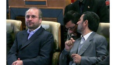 Iranian president Mahmoud Ahmadinejad, right, talks with a colleague as the mayor of Tehran, Mohammad Qalibaf, left, looks on.