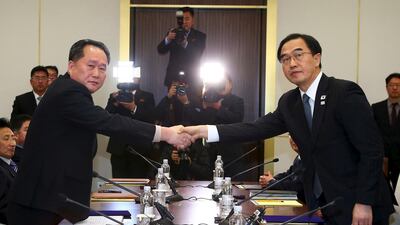South Korea's unification minister Cho Myung-gyun (R) shakes hands with North Korean chief delegate Ri Son-gwon during their meeting at the border truce village of Panmunjom in the Demilitarised Zone (DMZ) dividing the two Koreas on January 9, 2018. AFP
