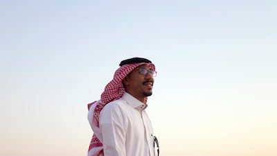 Mohammed, 27, a biology teacher from Tabuk watches the sun set in Haql. Reem Mohammed / The National