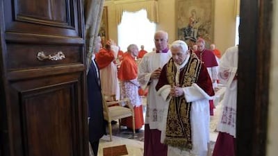 Pope Benedict XVI, centre, leaves after attending a meeting of Vatican cardinals in which he read a document in Latin to announce his resignation.