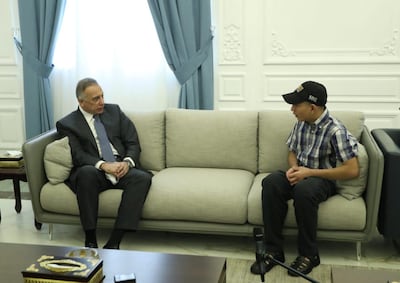 Iraqi Prime Minister Mustafa Al Kadhimi meets with Iraqi teenager Hamid Saeed, who was mistreated by members of security forces, after he was released from jail in Baghdad. Handout via Reuters