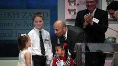 Ambassador Yousef Al Otaiba accepts gifts from children at a press conference at Children's National Medical Center, September 16, 2009, in Washington.