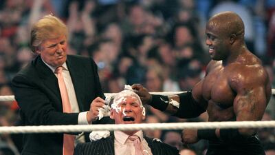 McMahon has a longstanding friendship with Donald Trump, who he often brought into the ring for storyline stunts. Here, McMahon has his head shaved by Trump and Bobby Lashley in 2007 after losing a bet. AFP