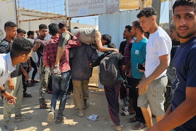 Palestinians carry a man who was injured as he was queuing for aid to a hospital in Rafah on Monday. AFP