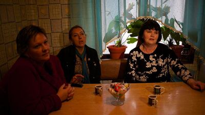 Alexandra Krivchenko, left, Nadezhda Kurovskaya, center, Irina Kharchenko, right, residents of 5a Akatsiy street drink tea in the village of Vesyoloye outside Sochi. Alexander Zemlianichenko / AP Photo