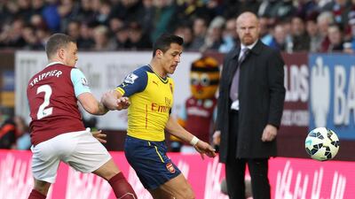 Burnley defender Kieran Trippier, left, vies with Arsenal striker Alexis Sanchez during their English Premier League match at Turf Moor in Burnley, north west England, on April 11, 2015. AFP PHOTO / LINDSEY PARNABY