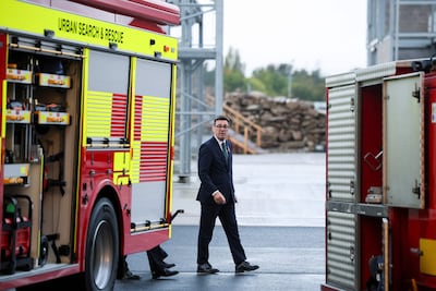 Britain's Prime Minister Andy Burnham meets fire service officers after his government advised households to stock up on emergency supplies. AFP