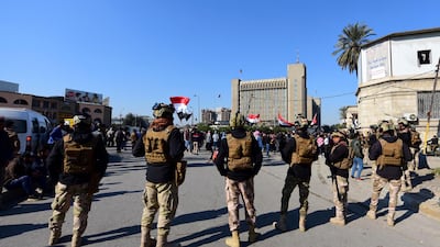 Iraqi soldiers stand guard as Iraqi university students chant slogans as they take part in a demonstration in front of the Iraqi ministry of higher educations in Baghdad, Iraq, 14 January 2020. EPA