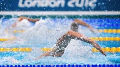 Swimmers in action during the men's 4x100m freestyle relay heats in London yesterday. Fabrice Coffrini / AFP