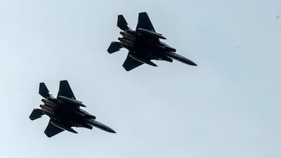 F-15 planes are seen from Endcliffe Park in Sheffield as warplanes from Britain and the United States stage a flypast tribute. PA via AP