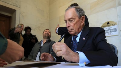 Michael Bloomberg fills out paperwork at the state Capitol in Little Rock on Tuesday. AP