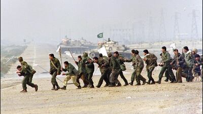 Iraqi soldiers carrying surrender flags on February 25, 1991 in Kuwait City. AFP