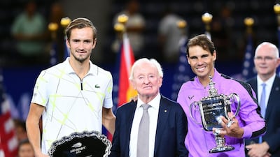 Rafael Nadal of Spain, right, holds the US Open trophy, next to Australian tennis great Rod Laver, centre, after his win over Daniil Medvedev. AFP