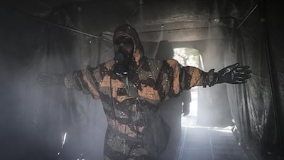 Members of Iran's Revolutionary Guard spray down streets and hospitals with disinfectants, March 1. Tasnim News Agency via AP