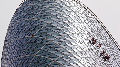 Rope Access cleaners from Grako clean the windows of the Capitol Gate tower in Abu Dhabi. Antonie Robertson / The National