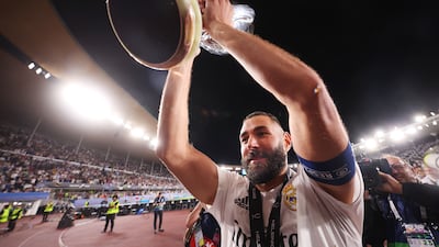 Karim Benzema of Real Madrid lifts the Uefa Super Cup trophy. The Frenchman svcored the second Real's two goals against Eintracht Frankfurt. Getty Images