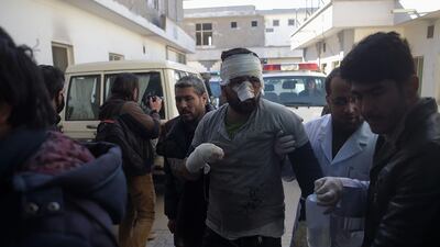 An injured Afghan man is led from an ambulance to hospital. Shah Marai / AFP Photo