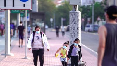 UAE residents wear face masks as part of safety measures to combat Covid-19. Victor Besa / The National