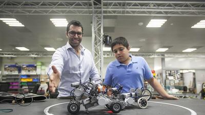 Georgios Korres, a research engineer at NYUAD, and Ibrahim Nayfeh with their robots. Mona Al Marzooqi / The National
