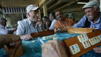 Retired men play Okey and smoke in Mutlu Tea House at Kasimpasa, a working-class district of Istanbul.