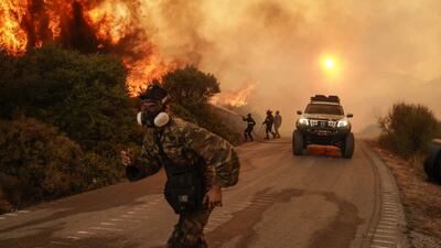 Firefighters and volunteers work to extinguish a wildfire in Krieza, on the island of Evia, Greece. Bloomberg