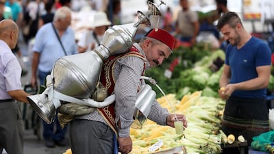 A man sells lemonade with an ottoman costume at a local bazaar in Istanbul. Turkey's economic confidence has dropped to its lowest level due to pressure on the country's trembling currency. EPA