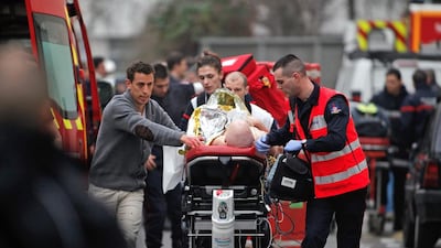One of the casualties of the terror attacks in Paris last week is transported by ambulance. Photo: Thibault Camus / AP