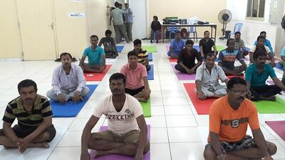 Yoga, meditation, reading and helping to finance children's education are offered to workers in Dubai by the Sapna project. Courtesy SmartLife