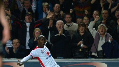 MK Dons on-loan Arsenal striker Benik Afobe celebrates scoring their fourth goal against Manchester United in a 4-0 win on Tuesday in the League Cup. Carl Court / AFP / August 26, 2014