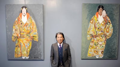 Fashion designer Kenzo Takada, aka Kenzo, posing near some of his self-portrait paintings in Paris on June 16, 2010. AFP