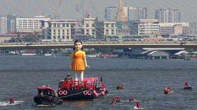 The world's largest Young-hee doll, aka 'Gokova', the iconic doll from Netflix's South Korean series 'Squid Game', is seen on a barge on the Chao Prayer River during the 'Squid Game' season 2 promotional event in Bangkok. EPA