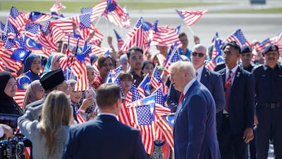 A flag-waving reception for US President Donald Trump at Kuala Lumpur International Airport in Malaysia. Bloomberg