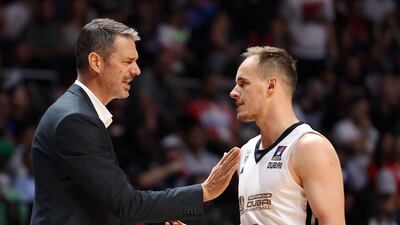 Jurica Golemac, head coach of Dubai Basketball, speaks with captain Klemen Prepelic