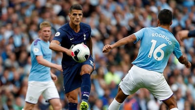 Tottenham's Erik Lamela, center, kicks the ball during the English Premier League soccer match between Manchester City and Tottenham Hotspur at Etihad stadium in Manchester, England. AP