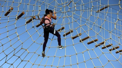 The National’s reporter, Afshan Ahmed, tests out the rope and zipline obstacles at the Aventura nature adventure park, at Mushrif Park in Dubai. Satish Kumar / The National