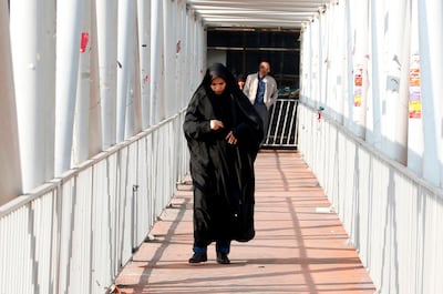 An Iranian woman wearing a chador walks down a street in the capital Tehran on February 7, 2018. AFP