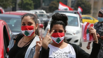 Anti-government demonstrators wearing face masks gesture as they pose during a protest, amid a countrywide lockdown to combat the spread of the coronavirus disease. Reuters
