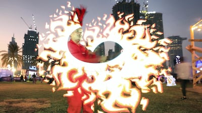 A performance artist dazzles in Burj Park.