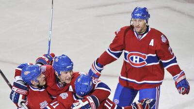 Montreal Canadiens' Andrei Markov, second from left, celebrates with teammates after a goal. Markov also had four assists in their win over the Buffalo Sabres on Friday.(AP Photo/The Canadian Press,Graham Hughes)