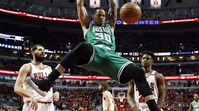 Boston Celtics' Gerald Green dunks in front of Chicago Bulls pair Nikola Mirotic, left, and Jimmy Butller. Nam Y Huh / AP Photo