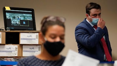 A Republican observer, right, watches as Lehigh County workers count ballots in Allentown. AP