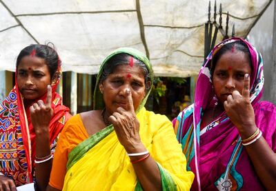 Indian voters show their ink-marked fingers after casting their vote on Ghoramara Island. AFP
