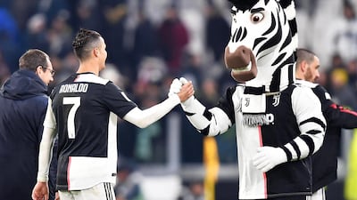 Cristiano Ronaldo celebrates with Juventus mascot J the zebra. AFP