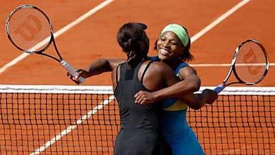 The Williams sisters hug after winning the doubles final.