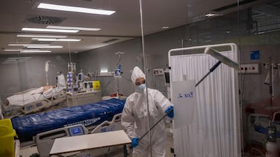 An employee of the new Nurse Isabel Zendal Hospital disinfects the Covid-19 ICU ward in Madrid, Spain. AP Photo