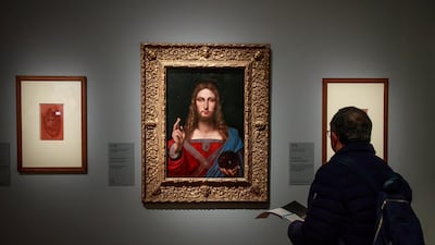 A visitor looks at the painting entitled 'Salvator Mundi' by Italian Renaissance artist Leonardo Da Vinci's workshop during an exhibition at the Louvre Museum in Paris, France. EPA