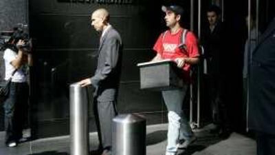 On the move: staff leave a Lehman Brothers office after the investment bank filed for bankruptcy protection last September. Company failures are increasing around the world.