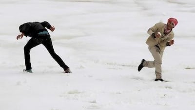 Men play in the snow after a heavy snowstorm in Amman, Jordan. Snowstorms closed most of the main streets in the capital and other cities in the past few days.